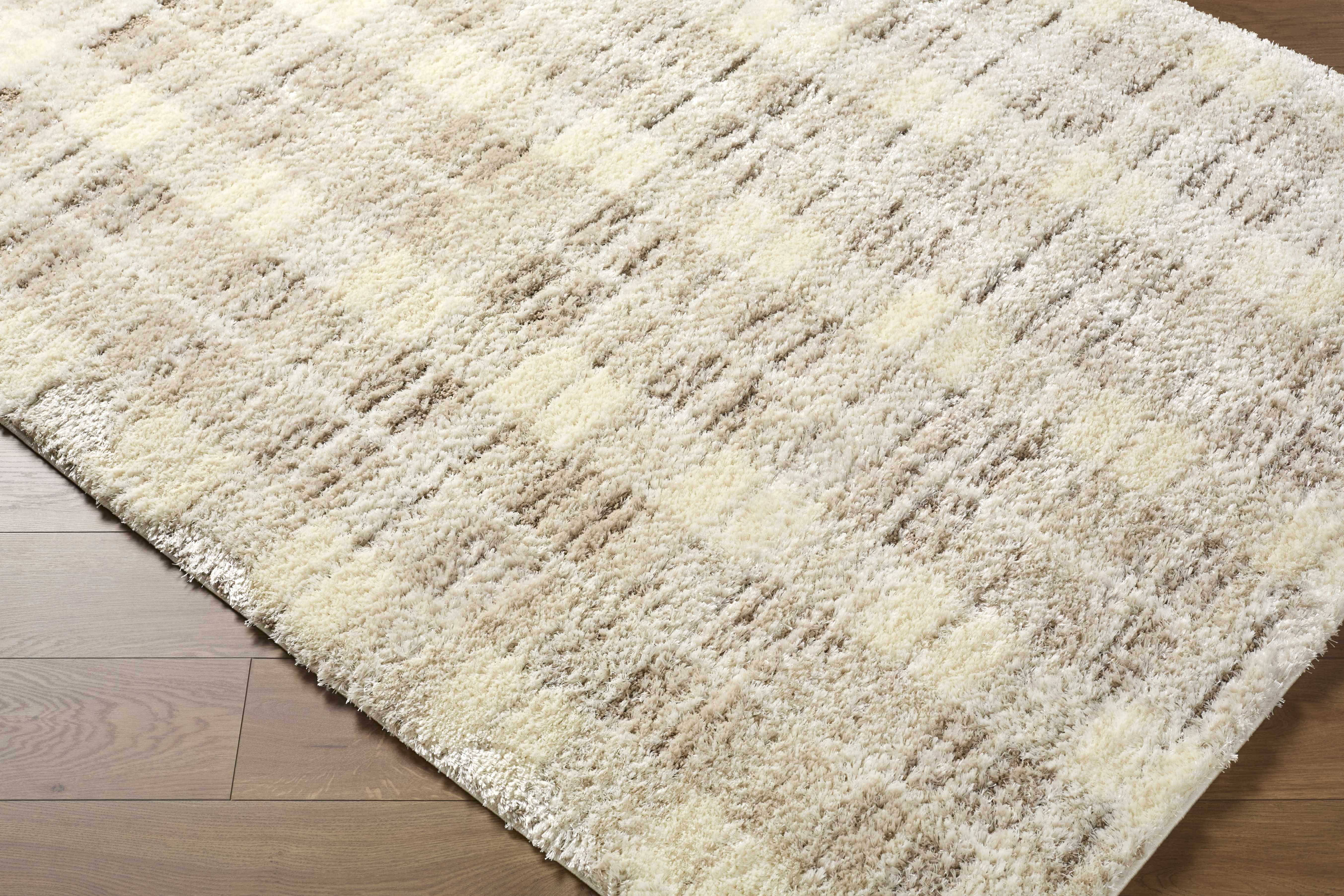 Cream checkered shaggy rug on a wooden floor